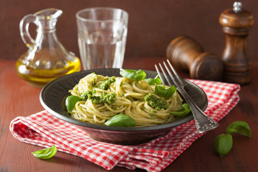spaghett pastai with pesto sauce over rustic table